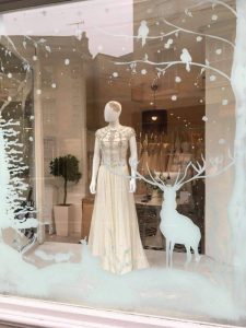 Christmas window painting, winter wonderland bridal shop window display in Bath.