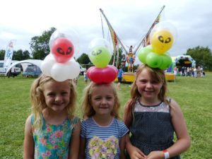 Children wearing alien balloon model head bands at event in Bristol.