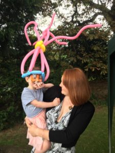 Princess poppy balloon model hat and face painting at a company event in Stroud, Glos.