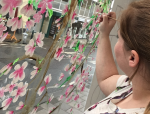 Artist painting windows.