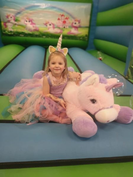 Unicorn party with themed bouncy castle and pony rides.