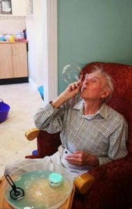 alex blowing bubble dementia care home sensory therapy entertainment