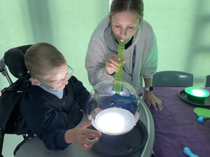 Blowing bubbles on lights for sensory party fun